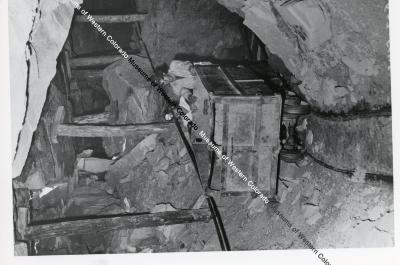 Two men with ore cart in a mine