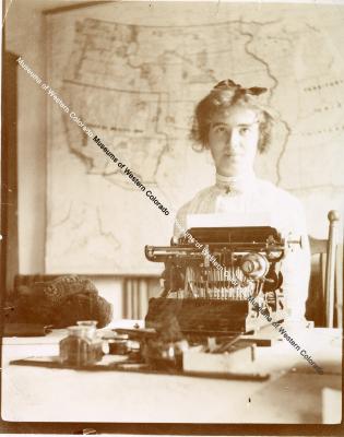 Lady Seated At Typewriter