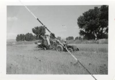 Tractor Pulling Hay Baler in Field