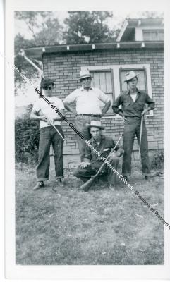 Four men in front of house