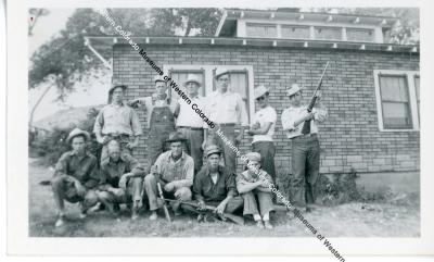 Group of men in front of house