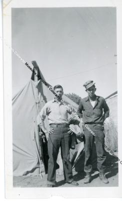 Two men in front of tent