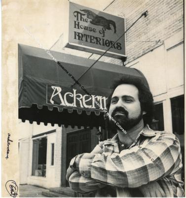 Ackerman in front of store