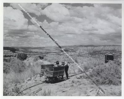Men Pushing Mine Cart Photograph