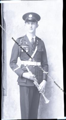 Negative of young man in band uniform with instrument