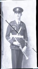 Negative of young man in band uniform with instrument