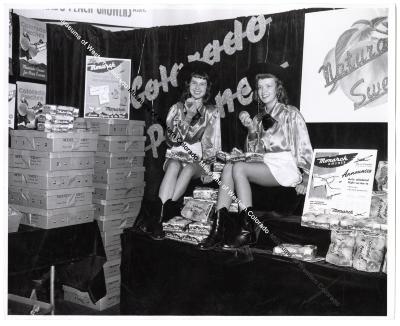Colorado Peaches Display with Two Women Holding Peaches