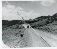 Dump truck coming up gravel road