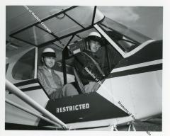 Two men in open restricted airplane
