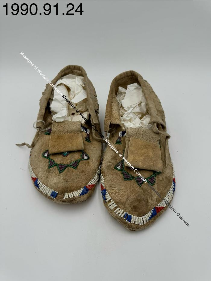 Beaded moccasins with fringe