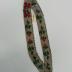 White beaded headband with green, red and blue floral designs