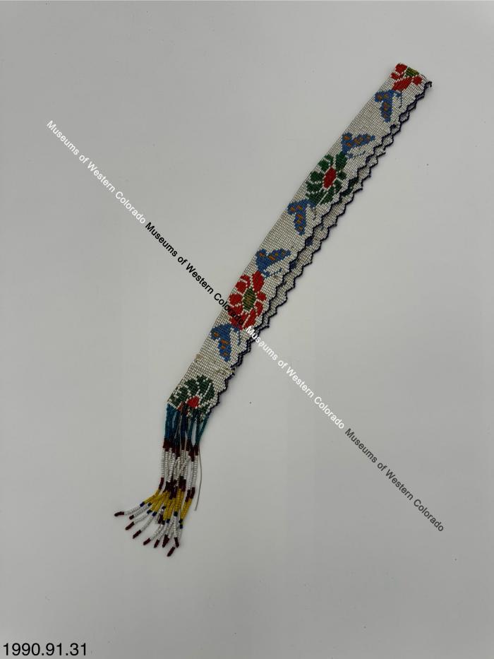 White beaded headband with multicolored flower and butterfly design