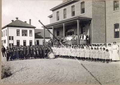 Group Portrait of Indian School Band in Front of School Buildings